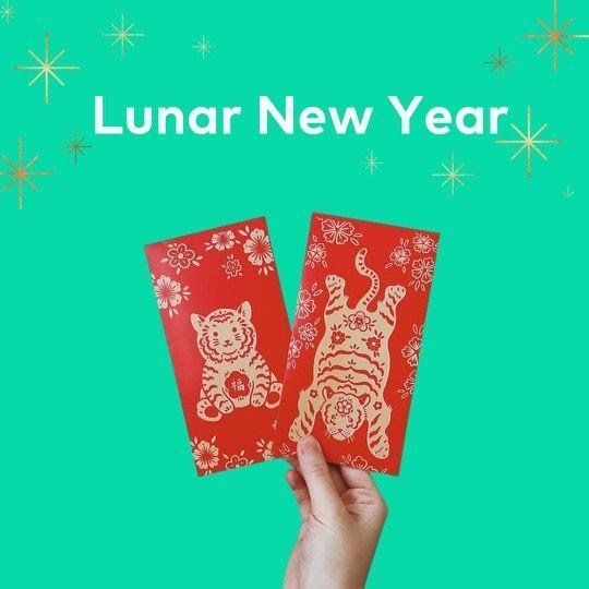 image of hand holding two lunar new year red envelopes.  benjamin talks explains what lunar new year is as part of financial literacy for kids